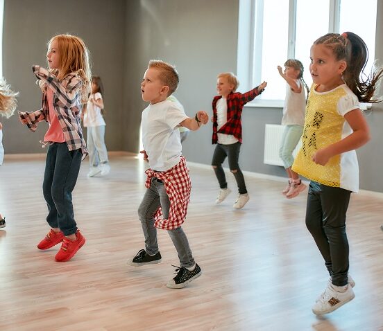 group of little boys and girls dancing while having class