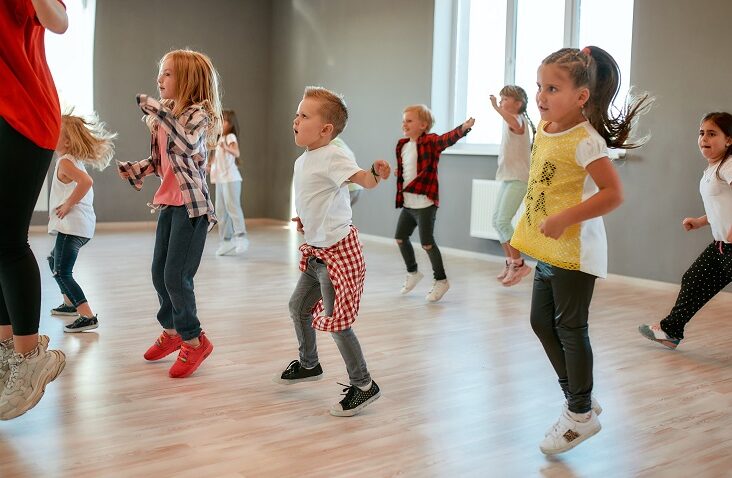 group of little boys and girls dancing while having class