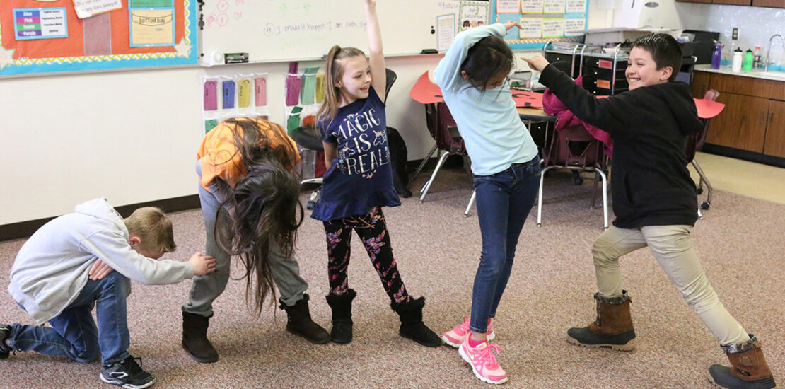 children dancing in classroom