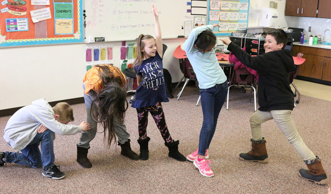 children dancing in classroom