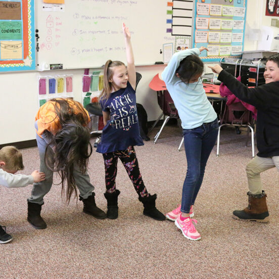 children dancing in classroom