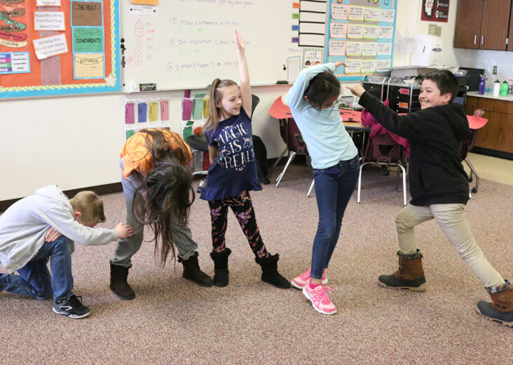 children dancing in classroom