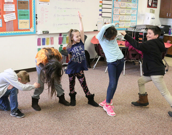 children dancing in classroom