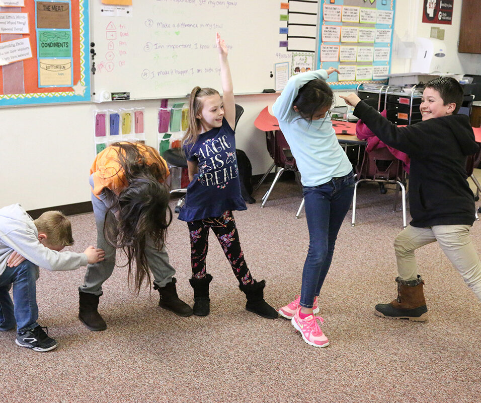 children dancing in classroom