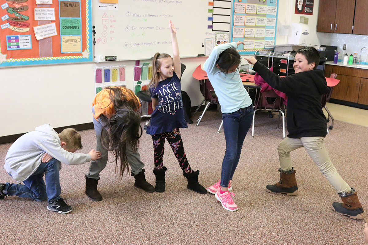 children dancing in classroom